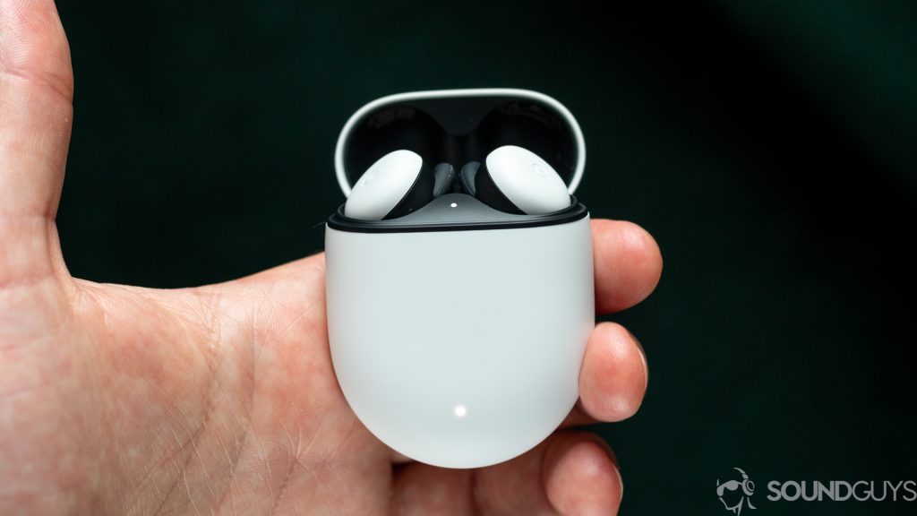 Man holding Pixel Buds charging case with the white new Google Pixel Buds inside and the lid open