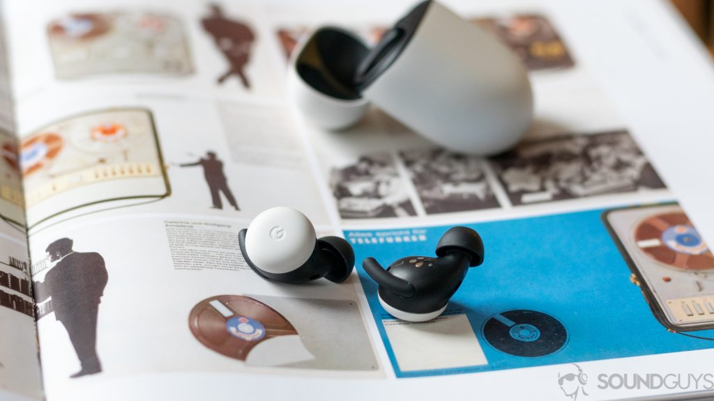 The new Pixel Buds on the page of a colorful book with open charging case in the background.