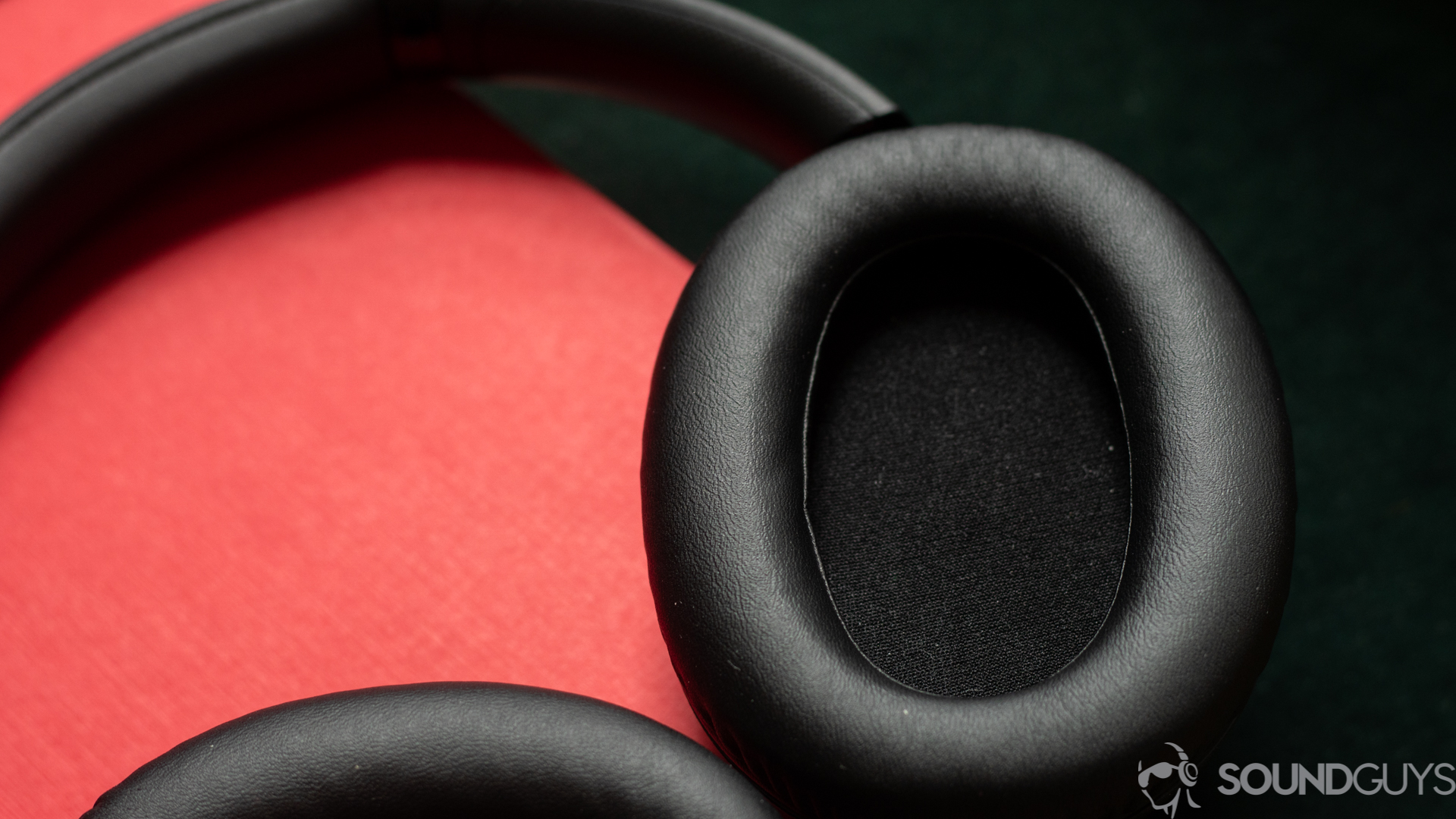 Close-up shot of the inside of the earcup for the Sony WH-CH710N on a red book