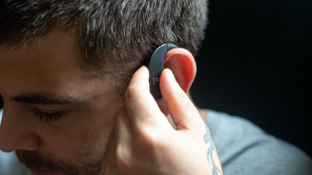 Man using the Anker Soundcore Spirit X2 playback controls.