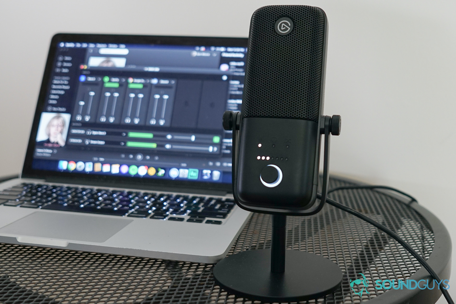 Elgato Wave 3 Macbook Wave Link The Elgato Wave:3 Microphone sits on a metal table in front of a MacBook Pro.