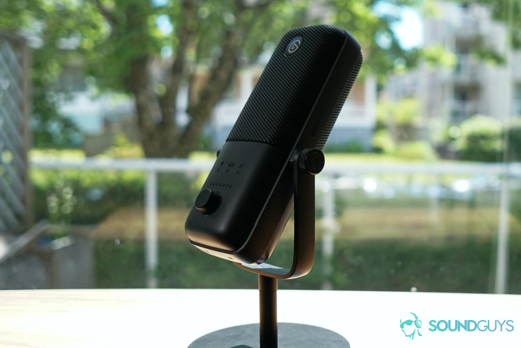 A picture of the Elgato Wave:3 sits near a window on a wooden table.