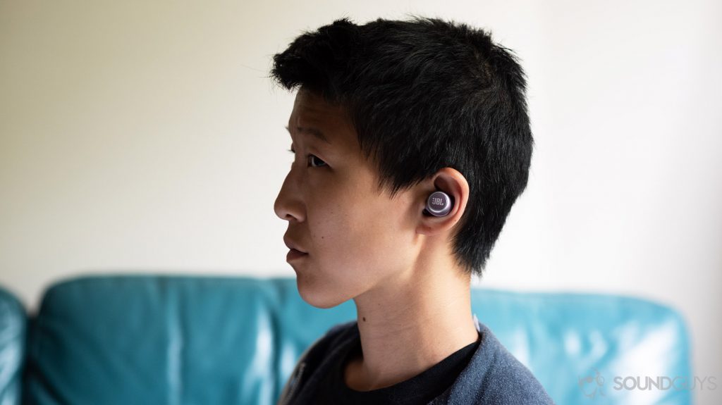 A picture of the JBL LIVE 300 TWS true wireless earbuds being worn by a woman in profile.