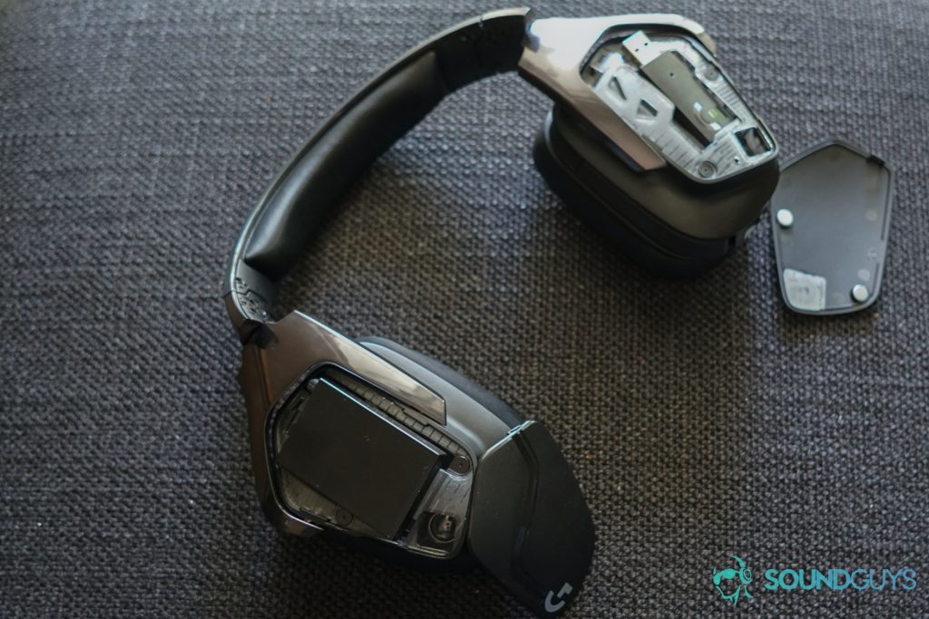 The Logitech G935 sits on a fabric surface with its side panels off.