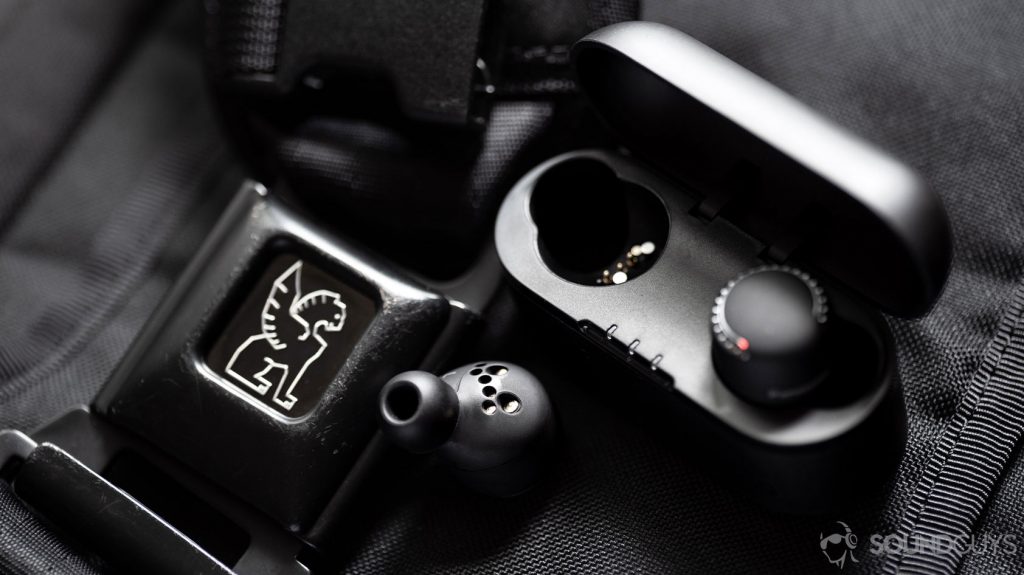 A picture of the Panasonic RZ-S500W noise canceling earbuds with one bud out of the case, revealing the multiple connector pins in the case and on the earbuds.