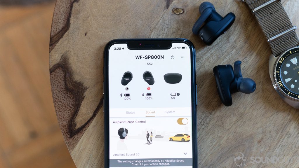 Sony WF-SP800N true wireless earbuds next to iPhone 11 Pro with Sony Headphones Connect app on the screen.