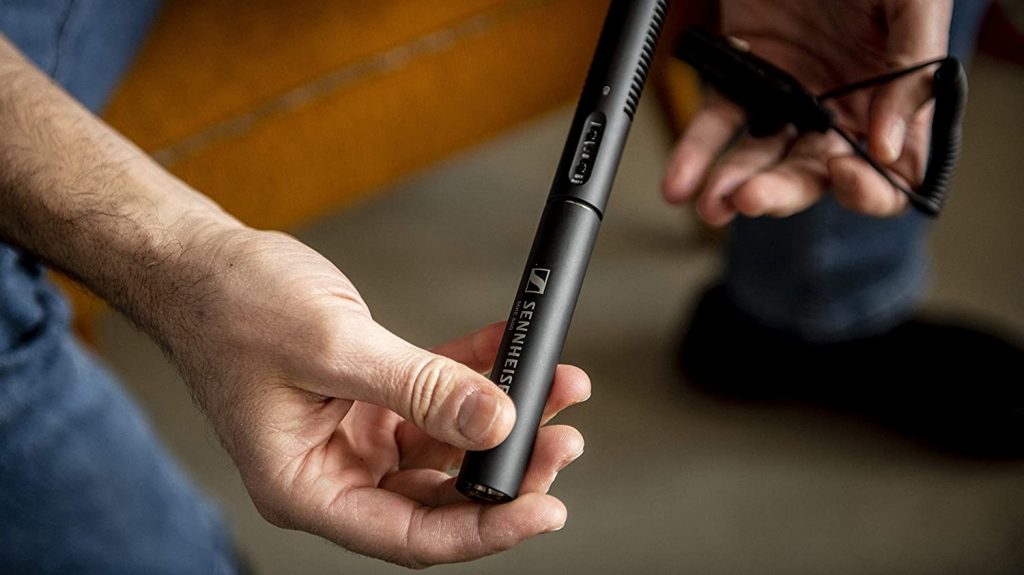 A picture of the Sennheiser MKE 600 shotgun microphone in a man's hand.