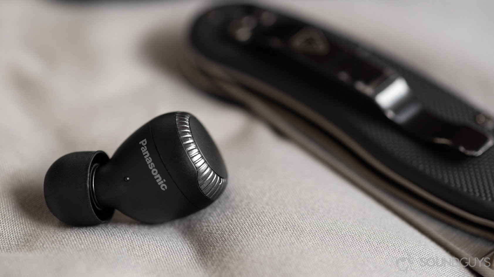 A photo of the Panasonic RZ-S300W true wireless earbud with the Panasonic logo in focus.