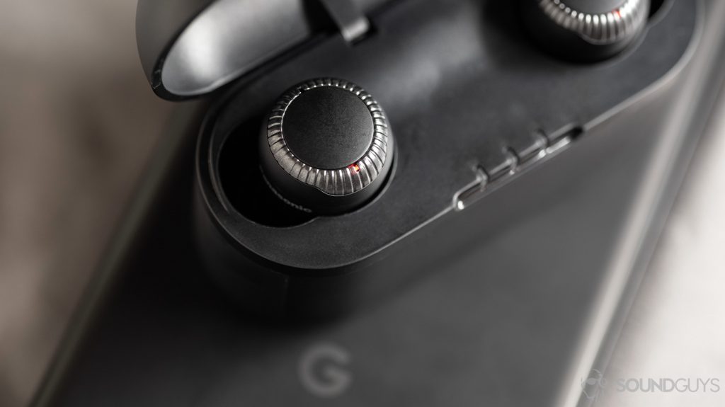 A photo of the Panasonic RZ-S300W true wireless earbuds with the left bud LED lit red on top of a Google Pixel smartphone.
