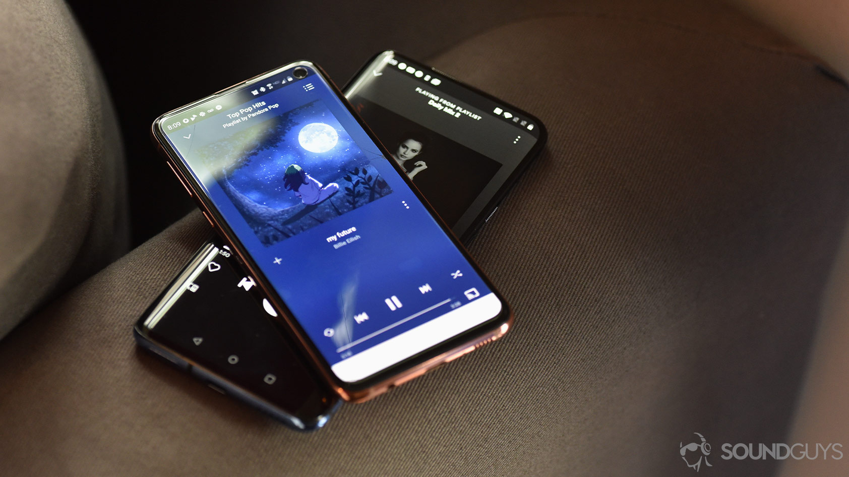 A picture showing Pandora vs Spotify UIs on two smartphones for comparison.