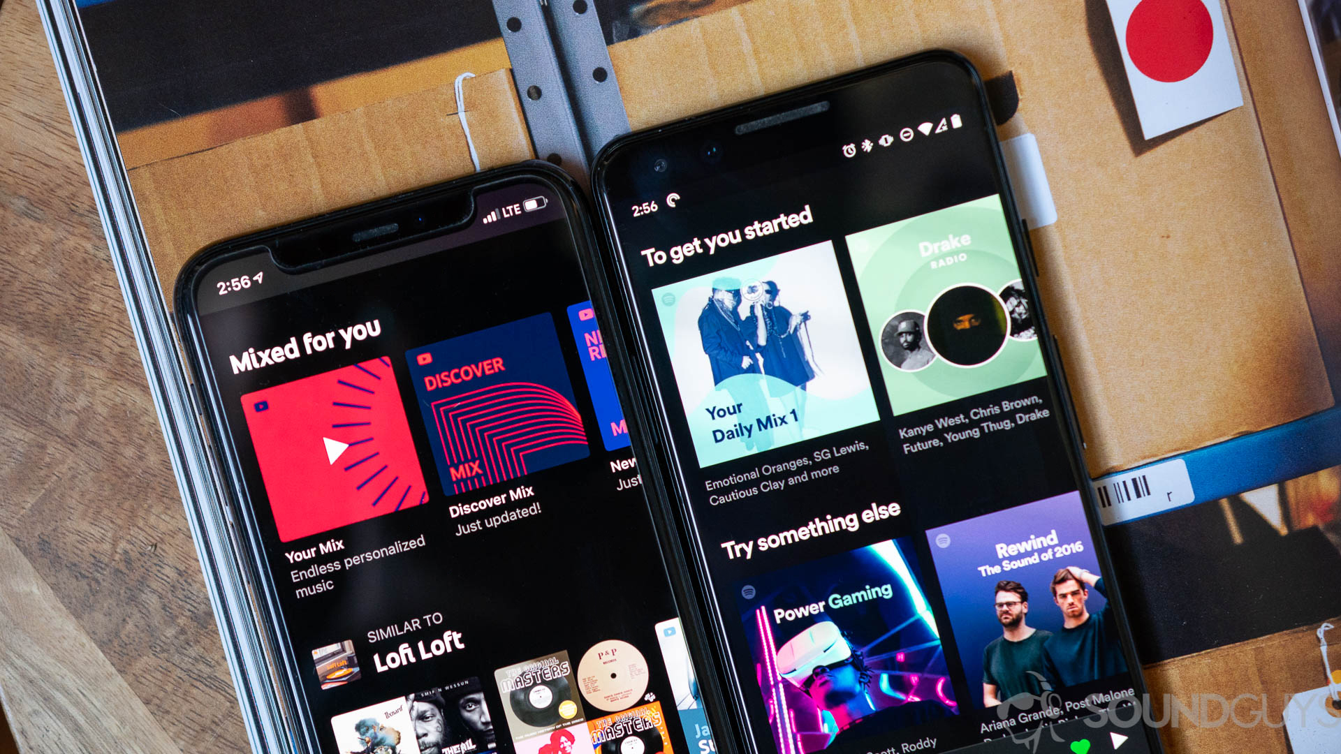 Close-up shot of the recommended playlists on Spotify and YouTube Music on two phones on a magazine