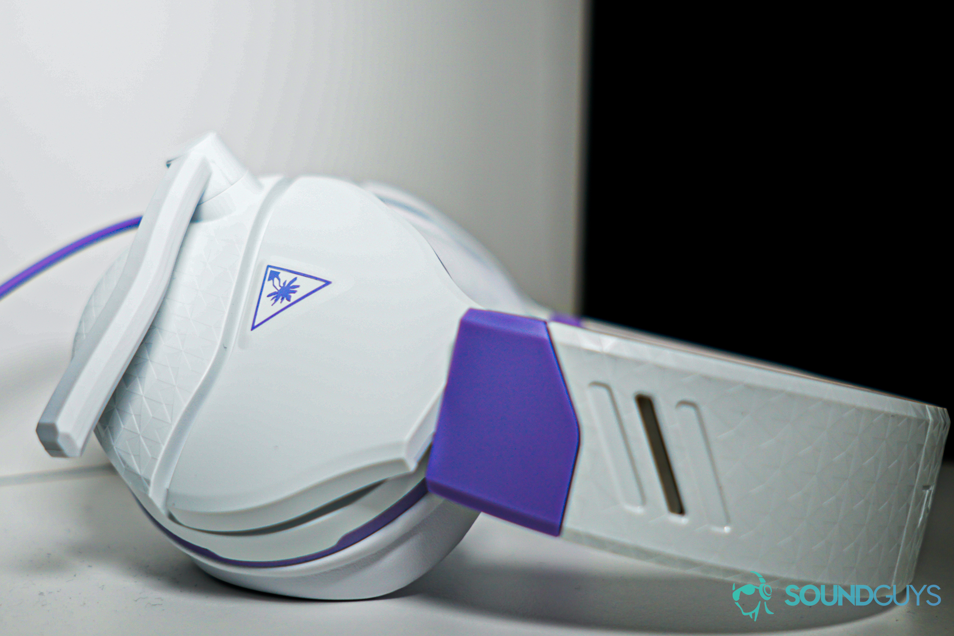 Turtle Beach Recon spark shelf shot The Turtle Beach Recon Spark gaming headset sits on a white shelf, laying on its side.