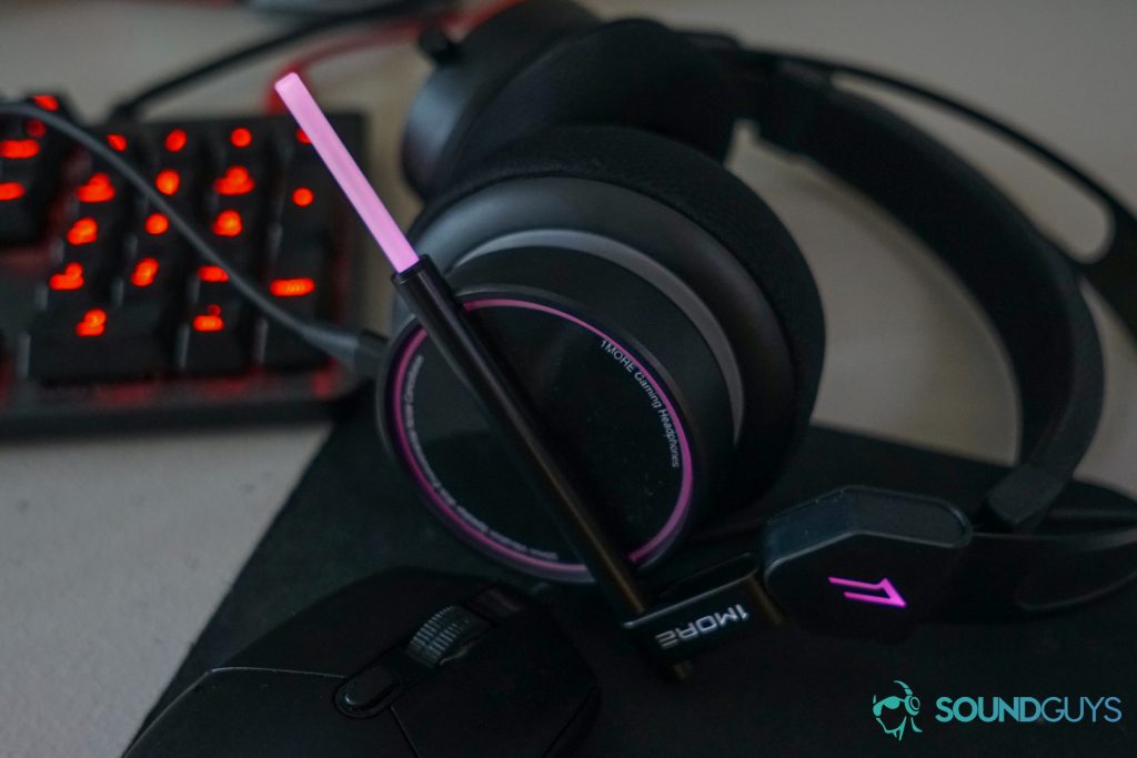 The 1more spearhead VR gaming headset sits on a desk near a Logitech gaming mouse and mechanical keyboard