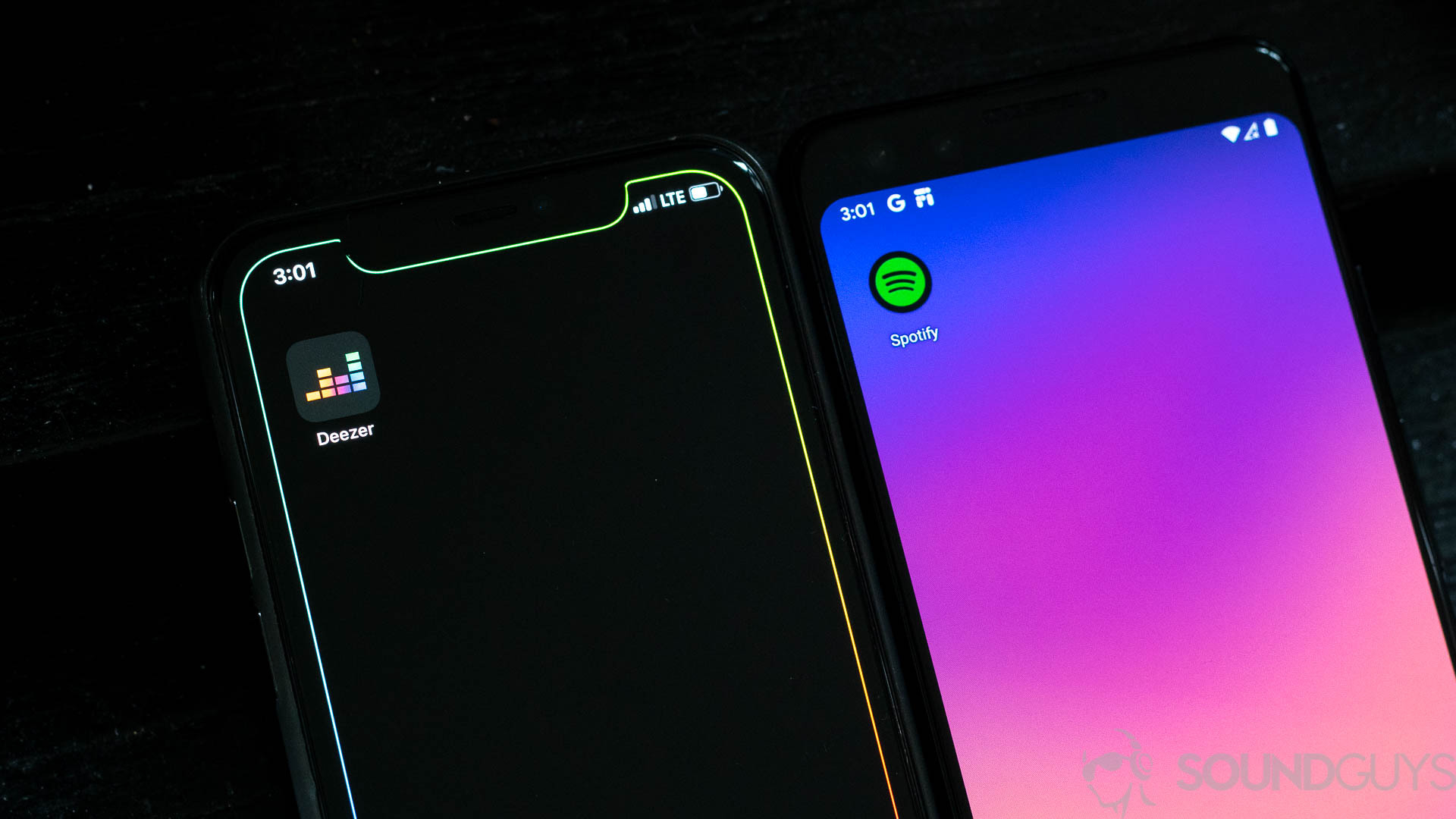 Deezer and Spotify apps side by side on two smartphones