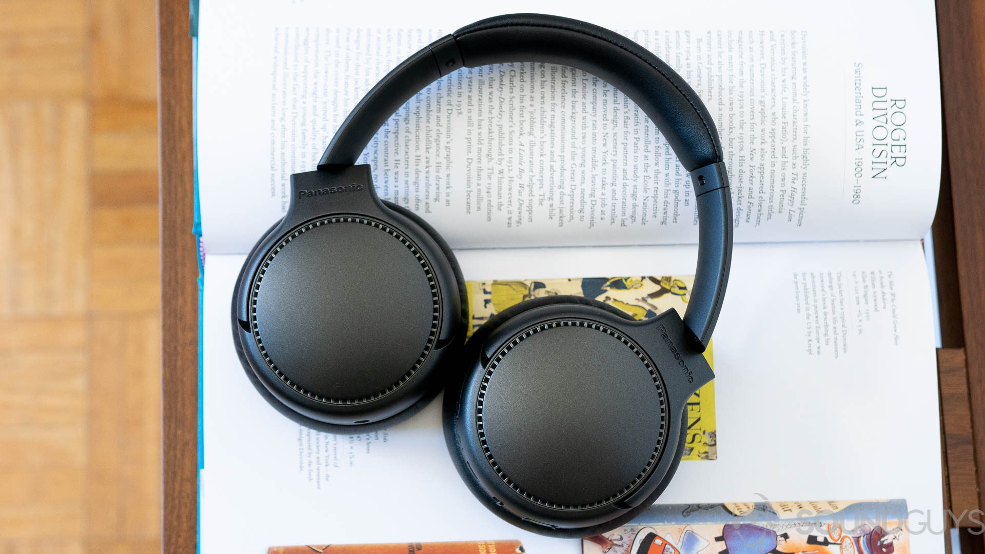 Panasonic RB-M700B headphones lying flat on an open book