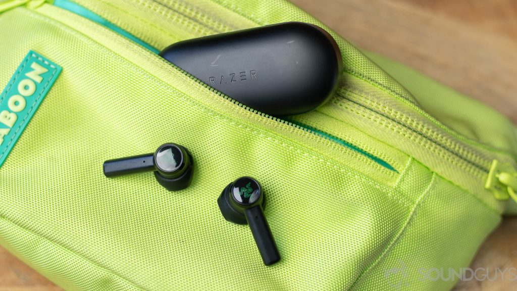 The Razer Hammerhead true wireless earbuds with the case on a neon green fanny pack.