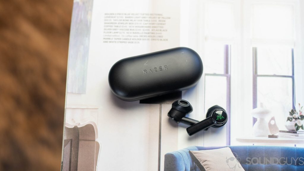 Shot of Razer Hammerhead True Wireless earbuds on a book