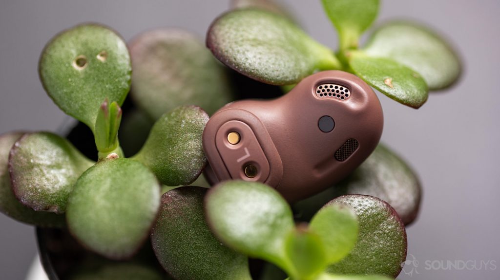 A picture of the Samsung Galaxy Buds Live noise canceling true wireless earbuds wing tip, air vent, IR sensor on a plant.