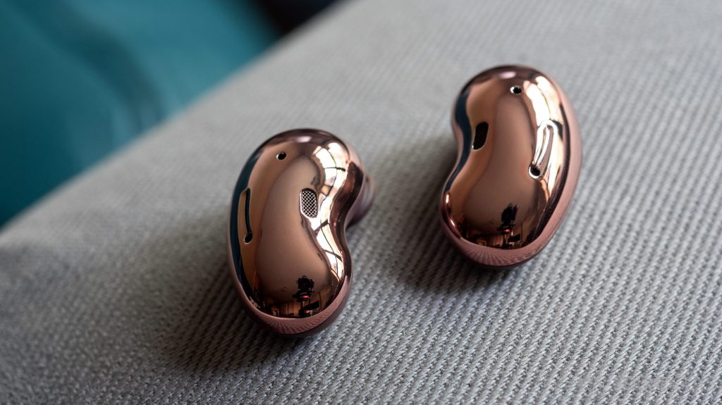 A picture of the Samsung Galaxy Buds Live noise cancelling true wireless earbuds bean shaped, reflective exteriors for a comparison in the Apple AirPods vs Samsung Galaxy Buds Live breakdown.