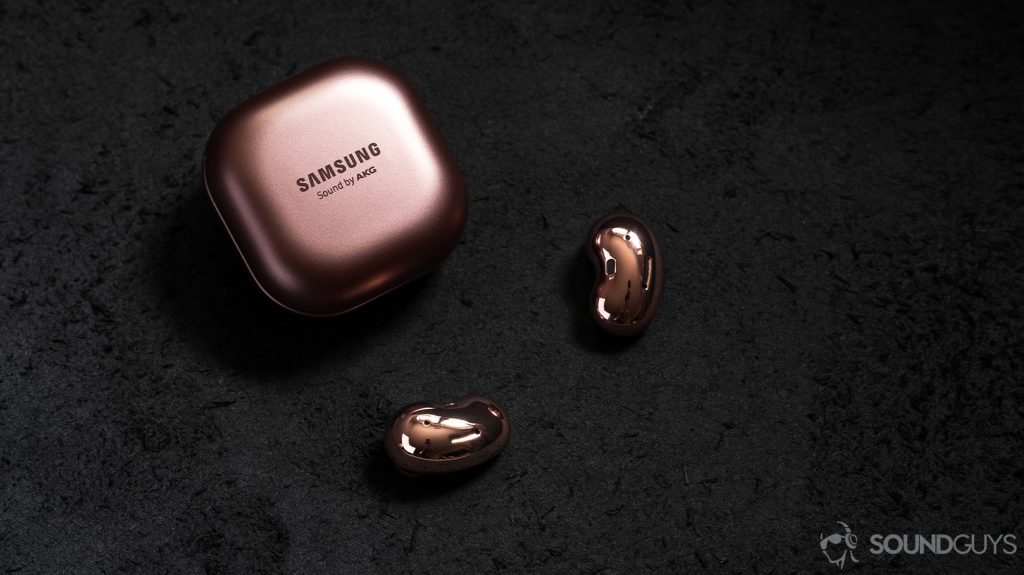 A picture of the Samsung Galaxy Buds Live noise cancelling true wireless earbuds outside of the closed case and on a black surface.