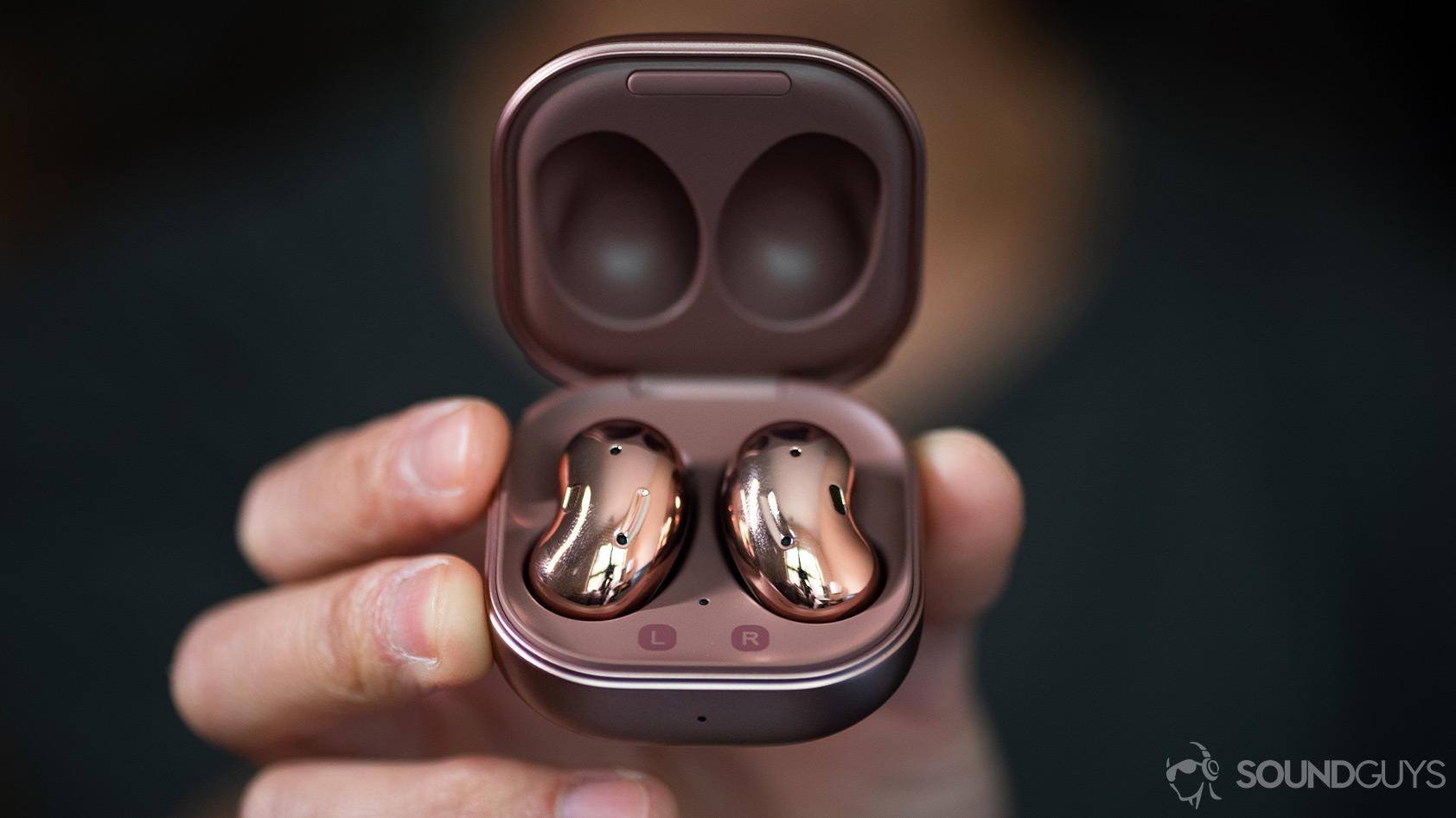 A picture of the Samsung Galaxy Buds Live noise canceling true wireless earbuds in the case being held in a hand.