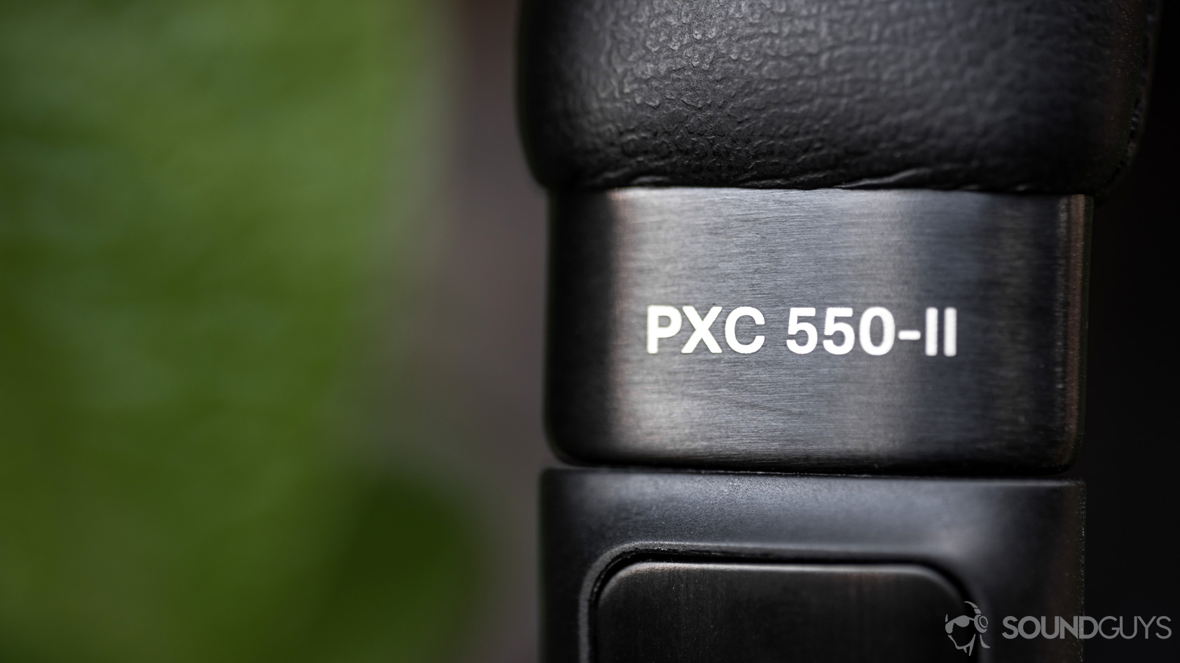 The Sennheiser PXC 550-II noise canceling headphones logo on the brushed aluminum accent of the headband.
