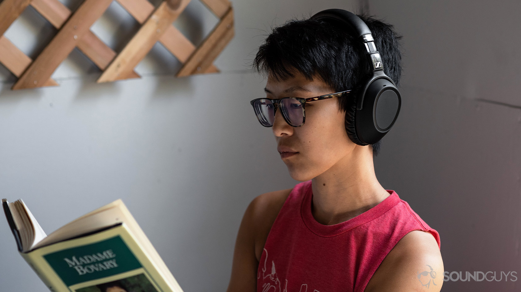 A picture of the Sennheiser PXC 550-II worn by a woman reading on a porch.