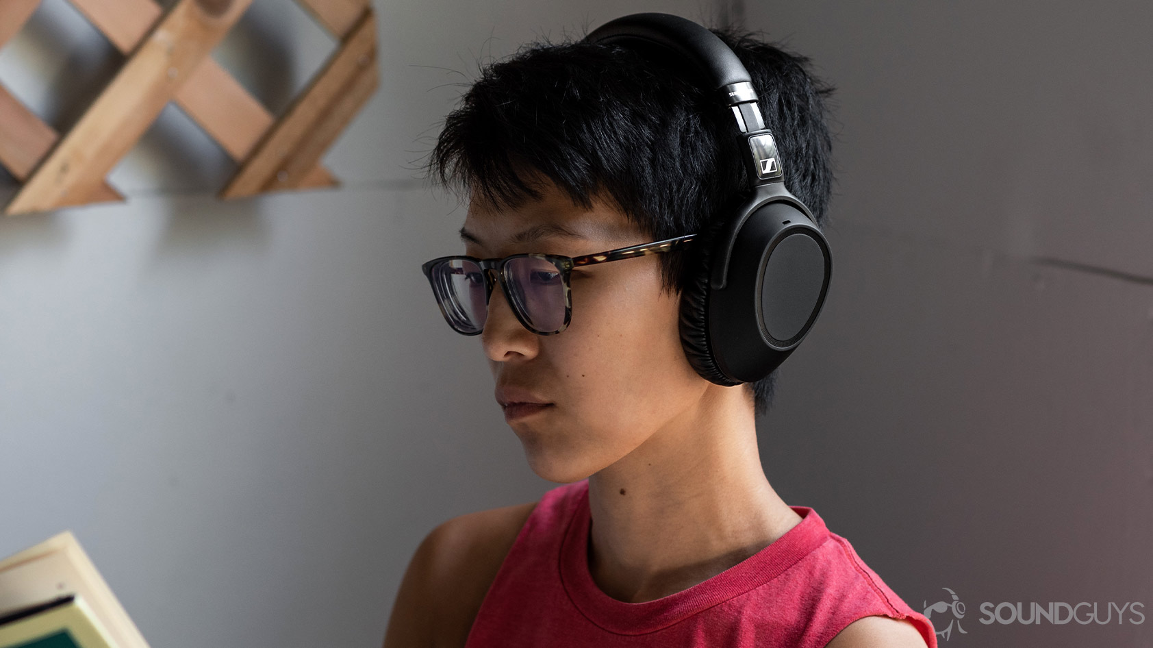 The Sennheiser PXC 550-II worn by a woman reading on a porch.