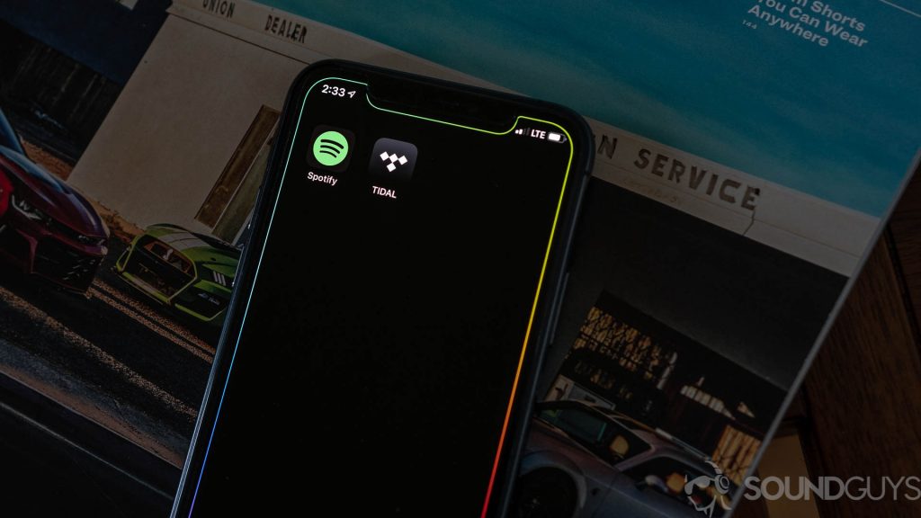 Spotify and Tidal's app icons on an iPhone, used to juxtapose Tidal vs Spotify.