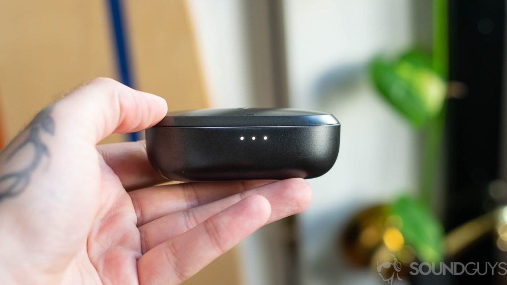 Man holding Anker Soundcore Spirit Dot 2 charging case with three LED lights on