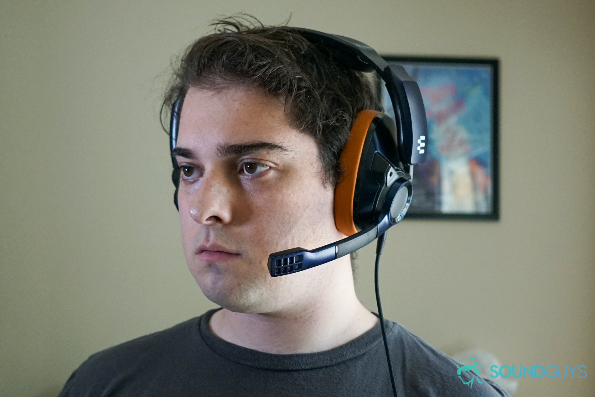 EPOS 602 headshot A man wears the EPOS Sennheiser GSP 602 gaming headset sitting at a computer