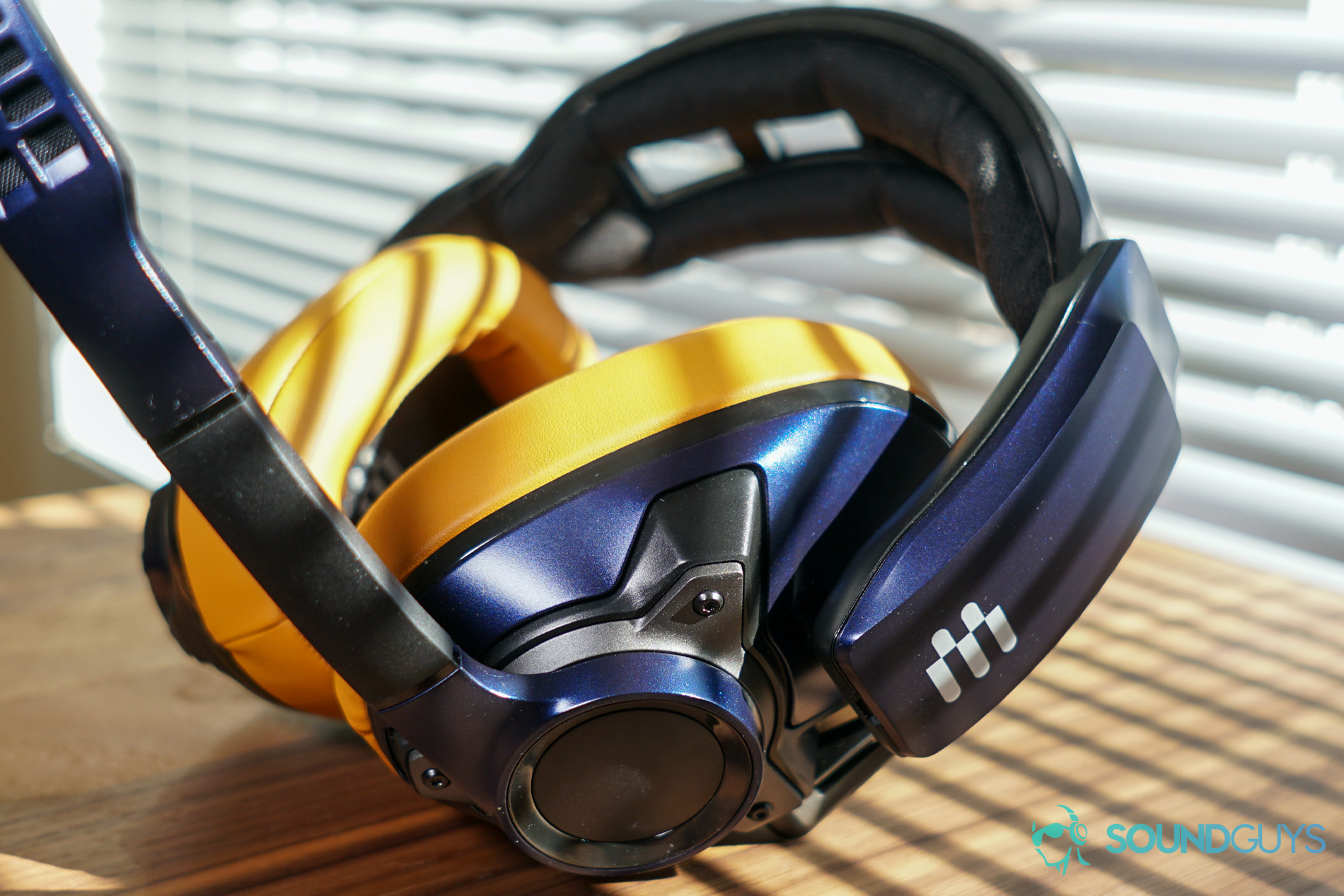 The EPOS Sennheiser GSP 602 gaming headset sits on wooden table in front of closed blinds