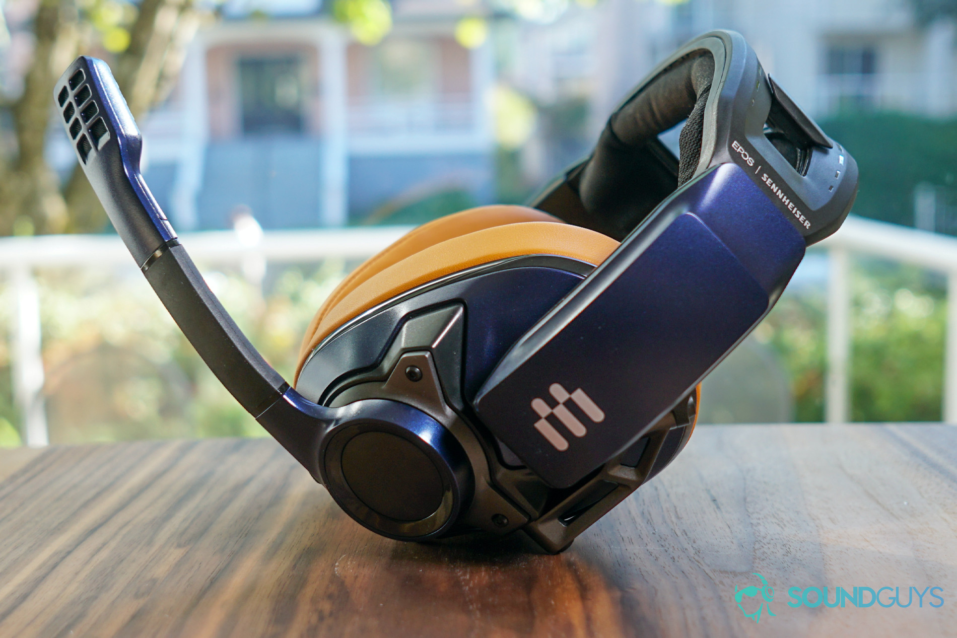 The EPOS Sennheiser GSP 602 gaming headset sits on a wooden table in front of an open window.