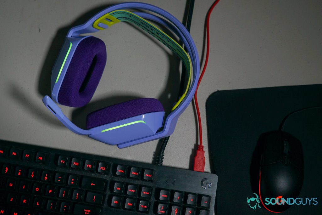The Logitech G733 gaming headset sits next to a logitech g413 carbon gaming keyboard and a logitech gaming mouse.