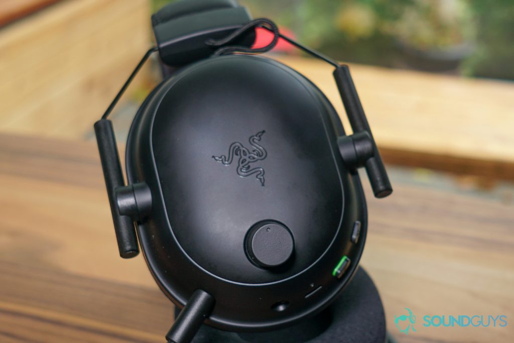 The Razer BlackShark V2 Pro gaming headset sits on its side, with the onboard controls and detachable microphone on display.