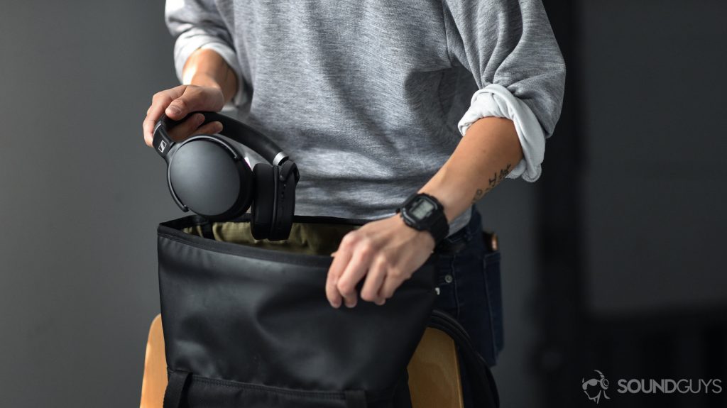 A picture of the Sennheiser HD 450BT noise canceling headphones as they're being removed from a black rucksack.