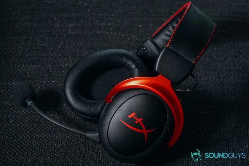 The HyperX Cloud II Wireless gaming headset lays on a fabric surface.