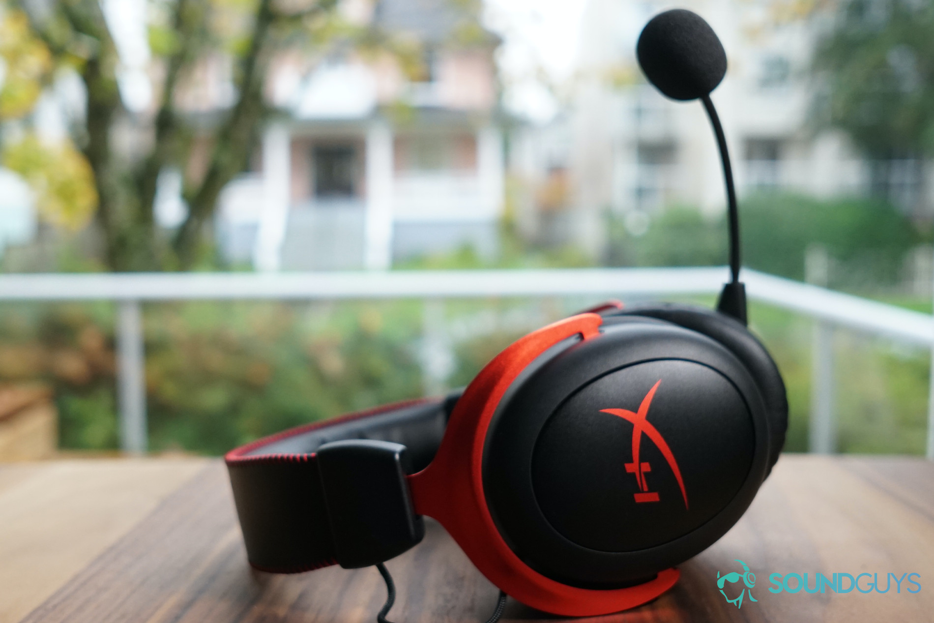 The HyperX Cloud II Wireless lays on a wooden table.