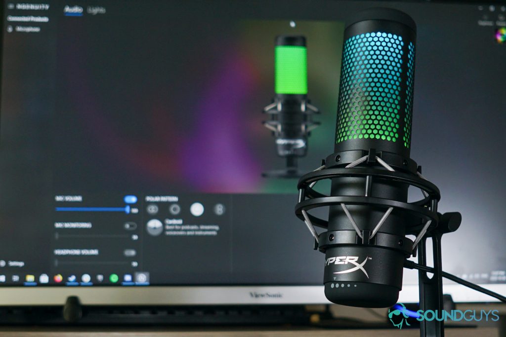 The HyperX QuadCast S stands in front of a monitor running HyperX NGenuity.