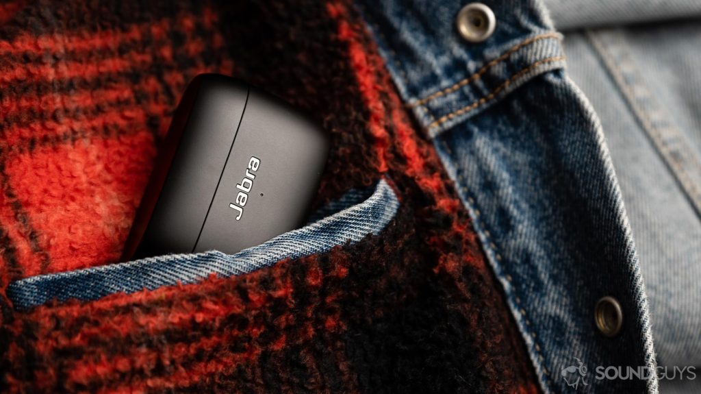 The Jabra Elite 85t noise cancelling true wireless earbuds case coming out of an interior jacket pocket.