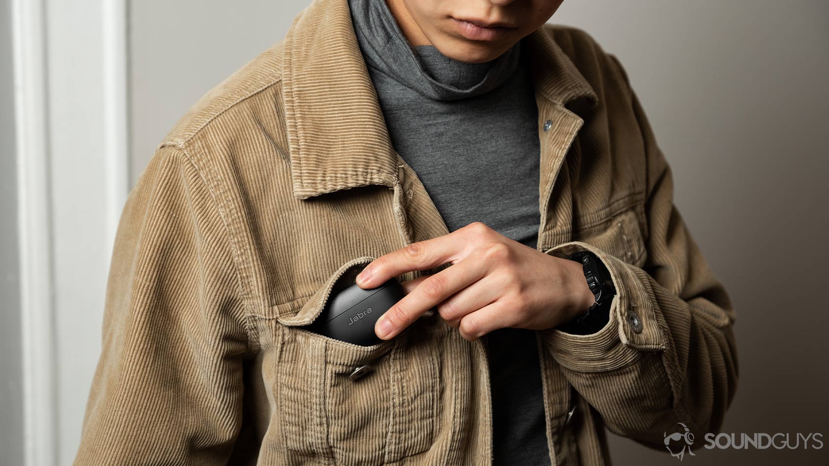 A woman pockets the Jabra Elite 85t noise canceling true wireless earbuds case.