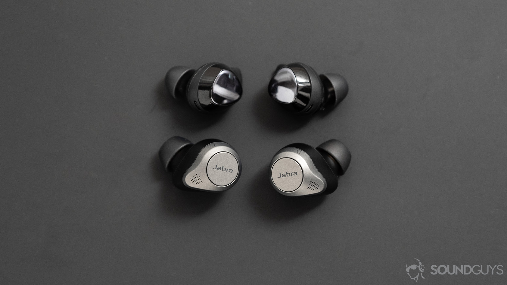 The Jabra Elite 85t noise canceling true wireless earbuds compared to the Samsung Galaxy Buds Plus, which are smaller than Jabra's buds.