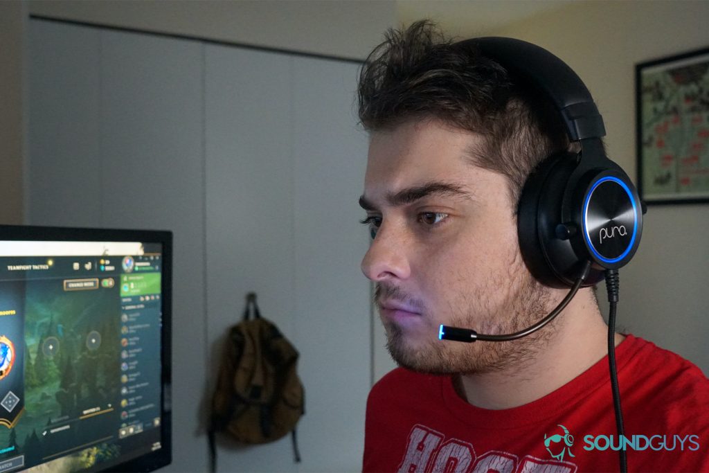 A man wears The Puro Sound Labs PuroGamer while sitting at a PC running League of Legends