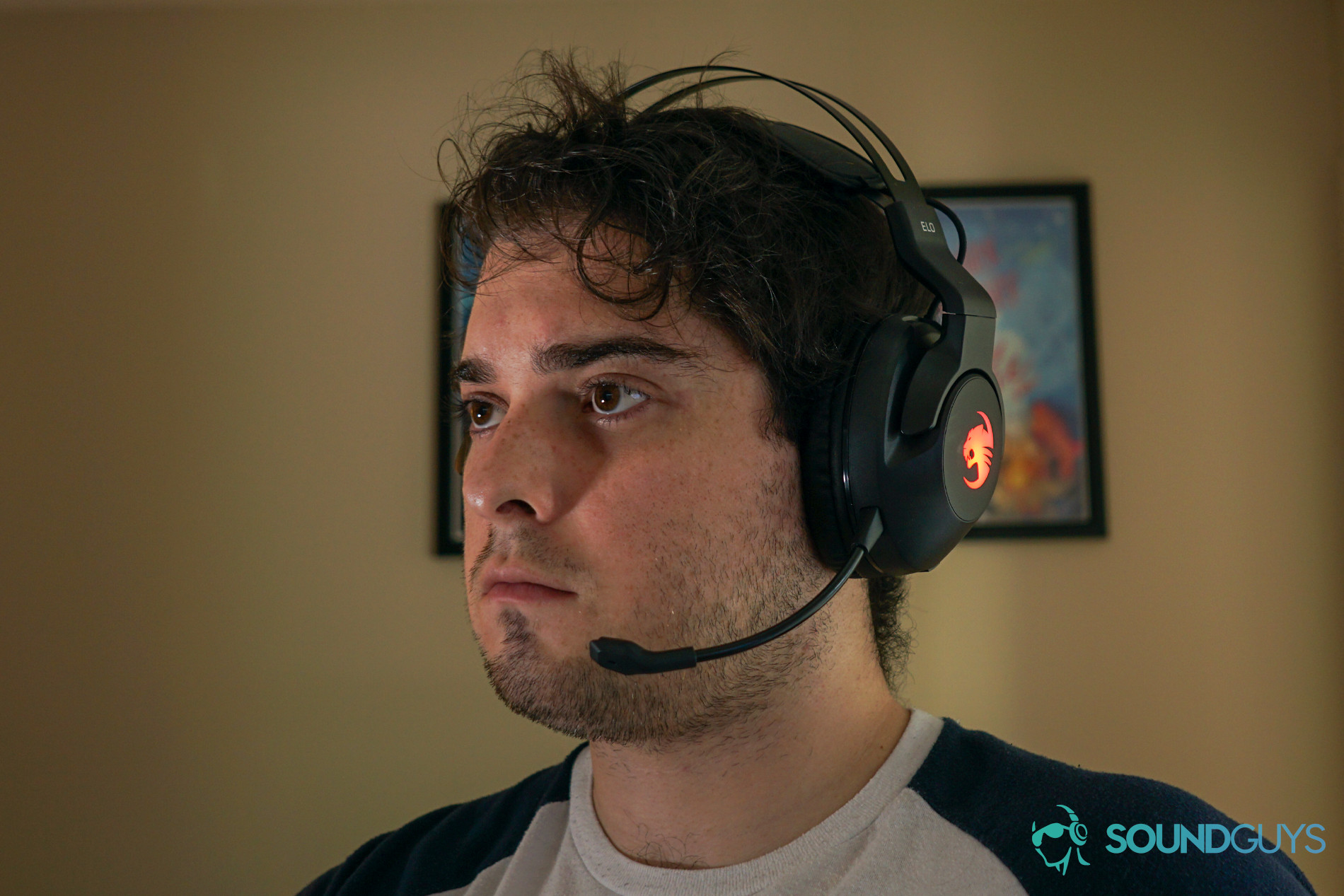 a man wears the Roccat Elo 7.1 gaming headset sitting at a pc