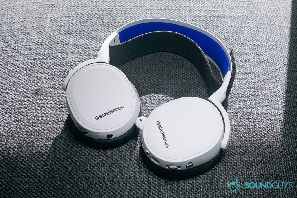 The SteelSeries Arctis 7P lays flat on a cloth surface