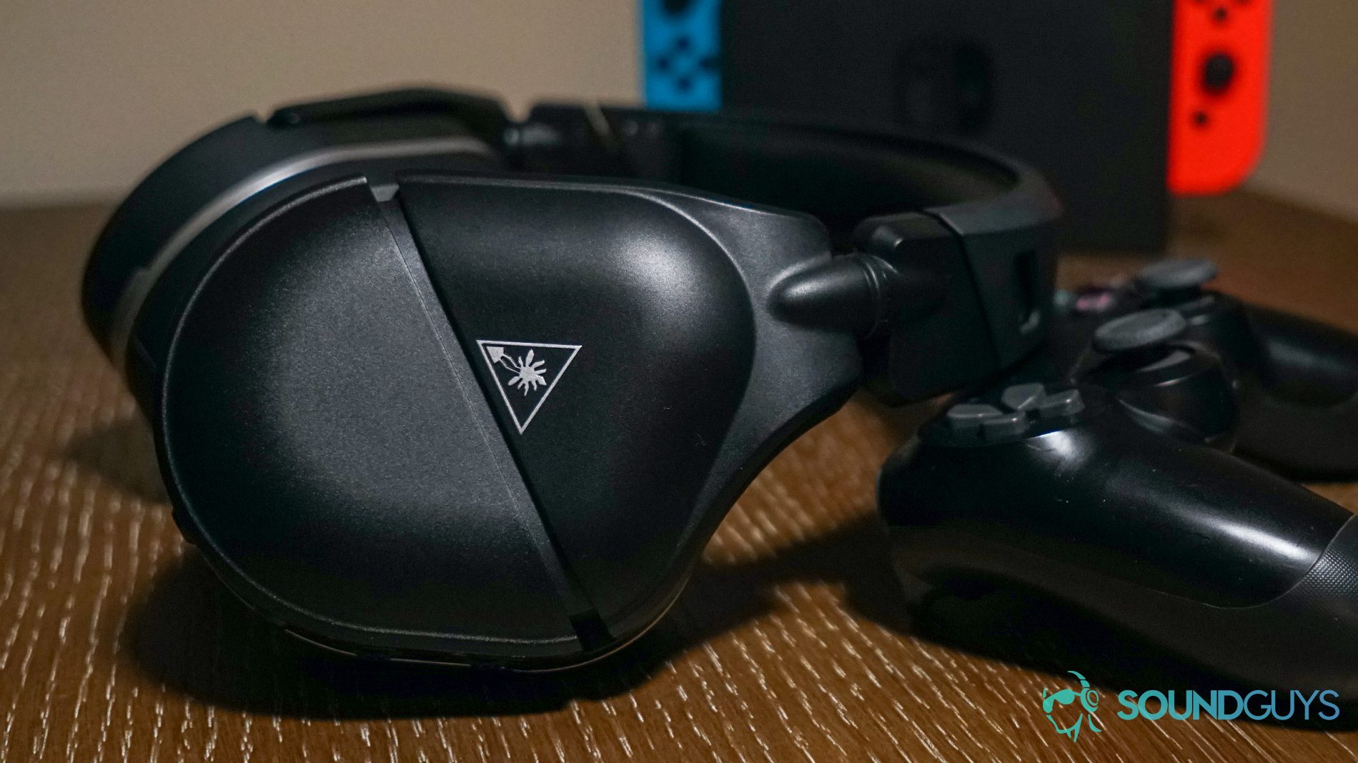 The Turtle Beach Stealth 700 Gen 2 gaming headset leans on a PlayStation DualShock 4 controller