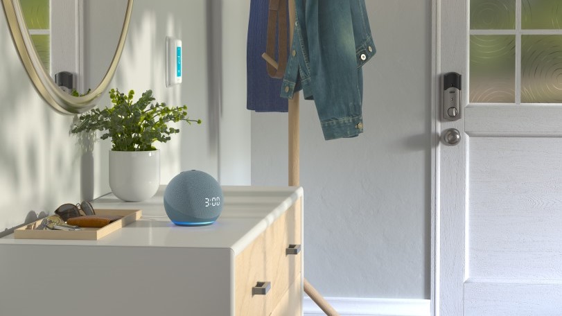 A picture of the Amazon Echo (4th Gen) in gray on an end table.