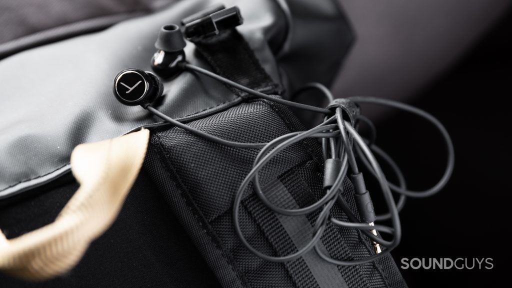 The Beyerdynamic Soul Byrd wired earbuds hooked around a black backpack.