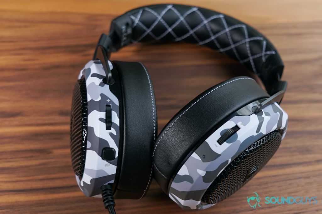 The Corsair HS60 Haptic lays on a wooden table with its controls facing up.