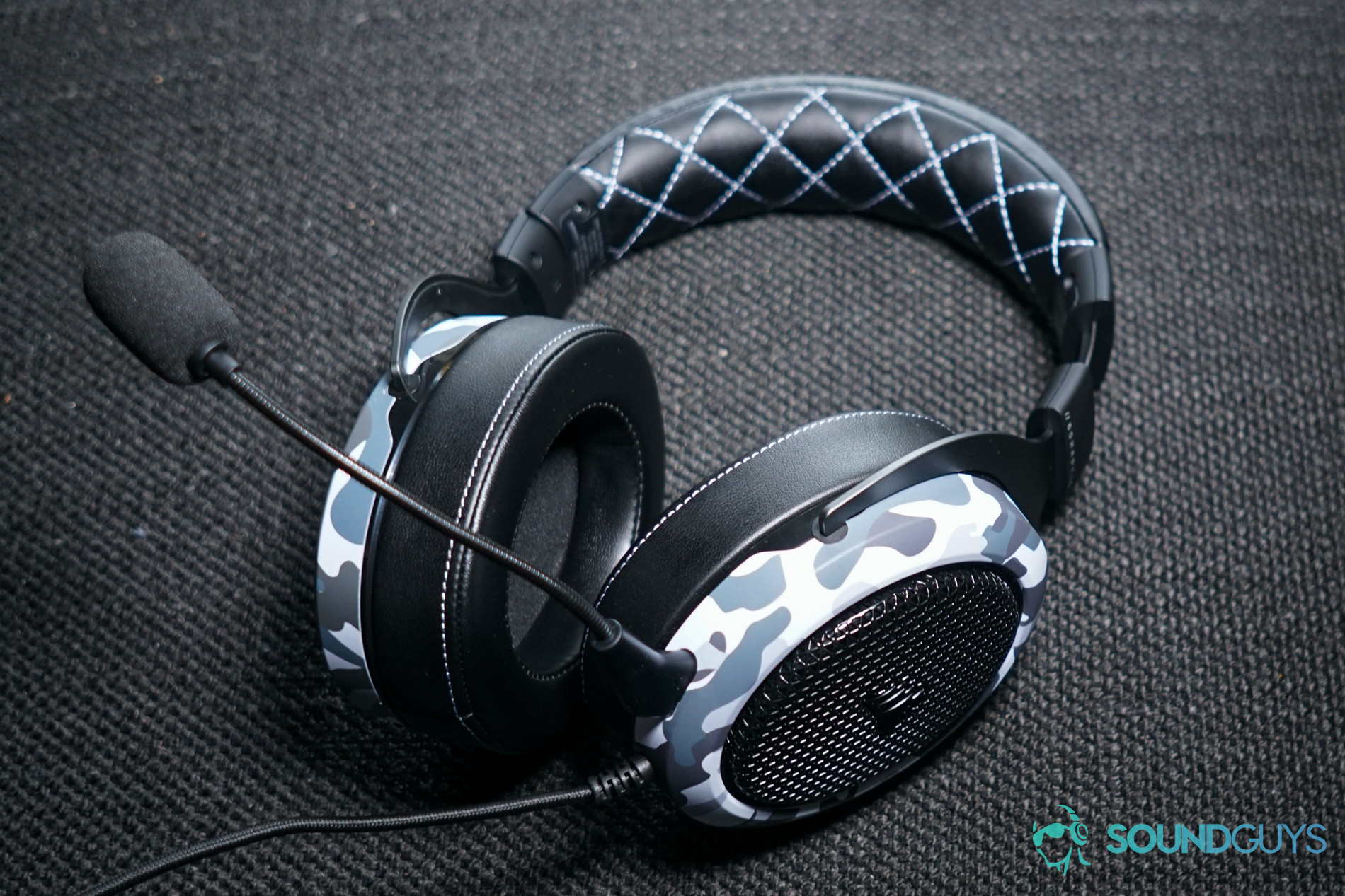 The Corsair HS60 Haptic gaming headset lays on a fabric surface